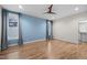 Spacious bedroom with hardwood floors, fan, and large windows at 917 S Blount St, Raleigh, NC 27601