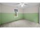 Empty bedroom with neutral carpet and two-tone green and white painted walls at 917 S Blount St, Raleigh, NC 27601