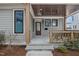 Covered front porch with wooden railing and ceiling, showcasing the home's inviting entryway at 917 S Blount St, Raleigh, NC 27601