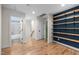 Bright hallway with custom shelving and an open doorway to a tiled bathroom at 917 S Blount St, Raleigh, NC 27601