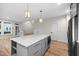 Kitchen island with white countertop and gray cabinets, complete with stainless steel microwave at 917 S Blount St, Raleigh, NC 27601