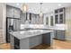 Modern gray kitchen with stainless steel appliances, subway tile backsplash, and marble countertops at 917 S Blount St, Raleigh, NC 27601