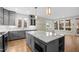 Elegant kitchen with gray cabinetry, marble island, and stainless steel appliances at 917 S Blount St, Raleigh, NC 27601