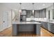 Modern gray kitchen with stainless steel appliances, subway tile backsplash, and marble countertops at 917 S Blount St, Raleigh, NC 27601