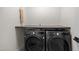 LG washer and dryer combo next to a shelf with wooden drying rack on the wall above at 917 S Blount St, Raleigh, NC 27601