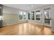 Sunroom with hardwood floors and large windows looking out to the backyard at 917 S Blount St, Raleigh, NC 27601