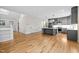 Expansive living space with modern gray kitchen and marble countertops, all with hardwood floors at 917 S Blount St, Raleigh, NC 27601