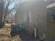 Solid brick home with AC unit ready for modern updates on a tree-filled lot under a clear blue sky at 922 N White St, Wake Forest, NC 27587