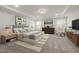 Well-lit main bedroom featuring a tray ceiling, neutral carpet, and coordinated furniture at 1018 Freestone Rd, Durham, NC 27703