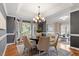 Stylish dining room featuring a chandelier, bay window, and space for entertaining guests at 110 White Bloom Ln, Cary, NC 27519