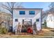 Rear exterior of the home featuring a wood deck with stairs leading to a large grass backyard at 1211 N Guthrie Ave, Durham, NC 27703