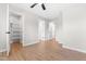 Bedroom featuring wood-look flooring, a ceiling fan and doors at 1211 N Guthrie Ave, Durham, NC 27703