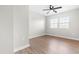 Bedroom featuring wood-look flooring, a ceiling fan and natural light from a double window at 1211 N Guthrie Ave, Durham, NC 27703
