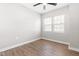 Bright bedroom featuring wood-look flooring, a ceiling fan and natural light from a double window at 1211 N Guthrie Ave, Durham, NC 27703