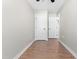 Spacious bedroom features wood-look flooring, neutral walls, and multiple doors at 1211 N Guthrie Ave, Durham, NC 27703