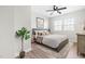 Stylishly decorated bedroom featuring wood-look floors, a ceiling fan, and lots of natural light at 1211 N Guthrie Ave, Durham, NC 27703