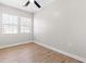Bright bedroom featuring wood-look flooring, a ceiling fan and natural light from a double window at 1211 N Guthrie Ave, Durham, NC 27703