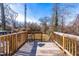 Wooden deck with a chair and railing that overlooks a large backyard space at 1211 N Guthrie Ave, Durham, NC 27703