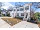 New townhome with a well-manicured lawn, a front walkway, and a white siding facade at 1211 N Guthrie Ave, Durham, NC 27703