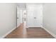 Bright hallway with wood-look flooring, access to doors, and white trim at 1211 N Guthrie Ave, Durham, NC 27703