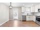 Eat-in kitchen with stainless steel appliances, granite countertops, and a back door to the outdoor patio at 1211 N Guthrie Ave, Durham, NC 27703