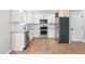 Well-equipped kitchen with stainless steel appliances, granite countertops, and sleek black hardware and finishes at 1211 N Guthrie Ave, Durham, NC 27703