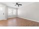 Bright living room featuring hardwood floors, a ceiling fan, and large windows for plenty of natural light at 1211 N Guthrie Ave, Durham, NC 27703