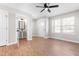 Inviting living room showcasing new flooring, a ceiling fan, and an adjacent half bathroom for added convenience at 1211 N Guthrie Ave, Durham, NC 27703