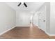 Bright living room features hardwood floors, ceiling fan, neutral paint, and entry to the kitchen area at 1211 N Guthrie Ave, Durham, NC 27703