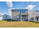 Back exterior view of a well-maintained two-story home with a spacious yard and screened porch area at 1236 Maple Branch Cir, Graham, NC 27253