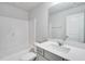 A well-lit bathroom features a shower-tub combo, a sleek vanity, and modern fixtures at 1236 Maple Branch Cir, Graham, NC 27253