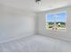 A bright bedroom features a large window offering plenty of natural light and neutral carpeting at 1236 Maple Branch Cir, Graham, NC 27253