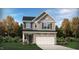 Charming two-story home with a stone-accented facade, attached two-car garage, and professionally landscaped yard at 1236 Maple Branch Cir, Graham, NC 27253