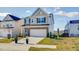Two-story home with stone accents, a two-car garage and manicured lawn at 1236 Maple Branch Cir, Graham, NC 27253