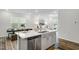 Open kitchen and living space showcasing quartz countertops and stainless appliances at 1236 Maple Branch Cir, Graham, NC 27253