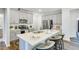 Modern kitchen features quartz countertops, stainless appliances, and bar seating at 1236 Maple Branch Cir, Graham, NC 27253