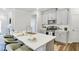 Modern kitchen with stainless steel appliances, white countertops, and breakfast bar at 1236 Maple Branch Cir, Graham, NC 27253