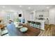 Open-concept kitchen with stainless steel appliances and breakfast bar with seating at 1236 Maple Branch Cir, Graham, NC 27253