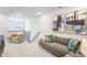 A modern living area featuring a comfortable sofa and chair for relaxing and entertaining at 1236 Maple Branch Cir, Graham, NC 27253
