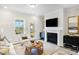 Elegant living room featuring a fireplace, backyard access, and decorative furniture at 1236 Maple Branch Cir, Graham, NC 27253
