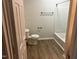 Bathroom with a toilet and tub with shower at 1647 Kenmore Dr, Clayton, NC 27520