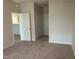 Neutral bedroom features carpet flooring and multiple doors at 1647 Kenmore Dr, Clayton, NC 27520