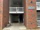 Apartment entrance with brick facade, stairs, and covered parking at 1647 Kenmore Dr, Clayton, NC 27520