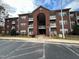 Charming brick apartment building with covered entrance and ample parking at 1647 Kenmore Dr, Clayton, NC 27520