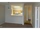 Kitchen featuring white appliances, wood cabinets, and a pass-through window at 1647 Kenmore Dr, Clayton, NC 27520
