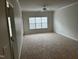 Bright living room featuring plush carpeting and a large window at 1647 Kenmore Dr, Clayton, NC 27520