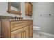 Bathroom with a wooden vanity, stone countertops, and updated fixtures at 1687 Galilee Rd, Smithfield, NC 27577