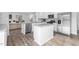 Open concept kitchen with large island, granite countertops, stainless steel appliances, and modern finishes at 1748 Post Oak Dr, Haw River, NC 27258