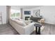 Bright living room features a large window, hardwood floors, and a fireplace with mounted TV at 1748 Post Oak Dr, Haw River, NC 27258
