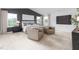 Spacious main bedroom with a plush bed, accent wall, and comfortable seating area at 1748 Post Oak Dr, Haw River, NC 27258